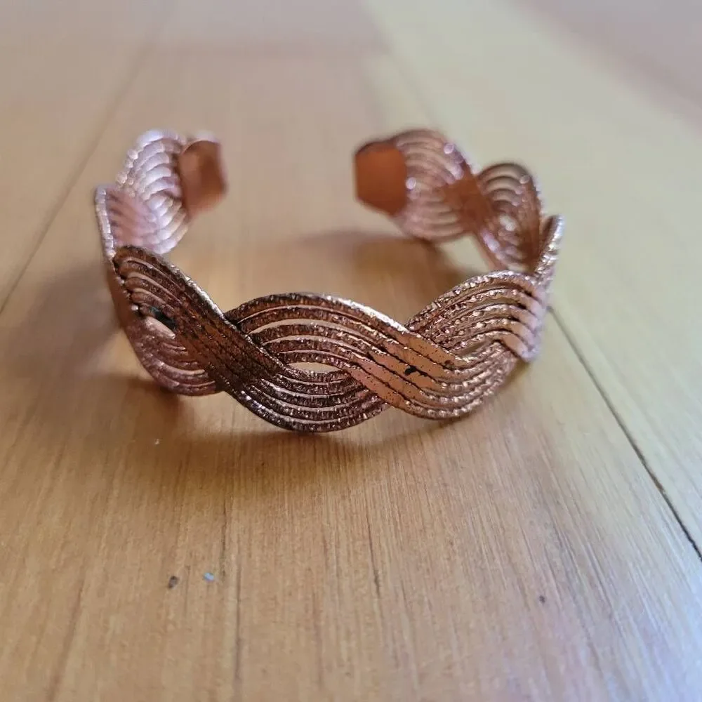 Set of two bracelets copper colored wavy bangle and stretchy beaded multicolored